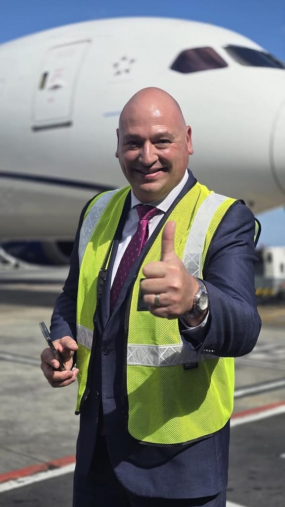 Alderman James Vos standing in front of an aircraft