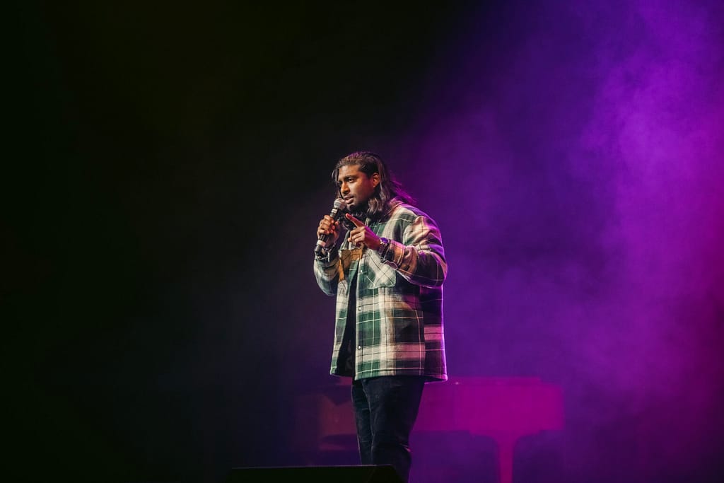 Jaryd Pillay on stage performing stand up comedy