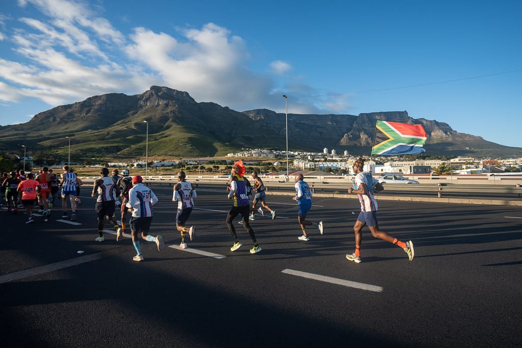 Cape Town Marathon runners on Nelson Mandela Boulevard, Foreshore, with Table Mountain as backdrop