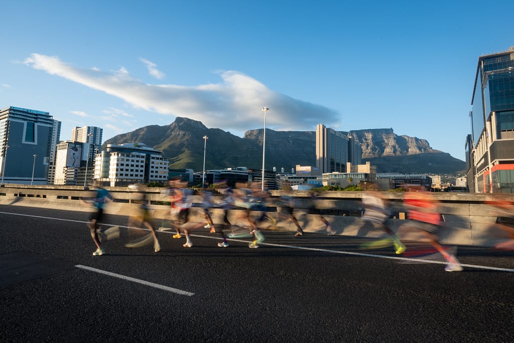 Sanlam Cape Town runners on Nelson Mandela Boulevard with Table Mountain as backdrop