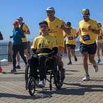Wings For Life runners and wheelchair participants on Sea Point Promenade