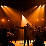 Lebo M with an Orchestra on stage at Artscape Theatre