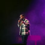 Jaryd Pillay on stage performing stand up comedy