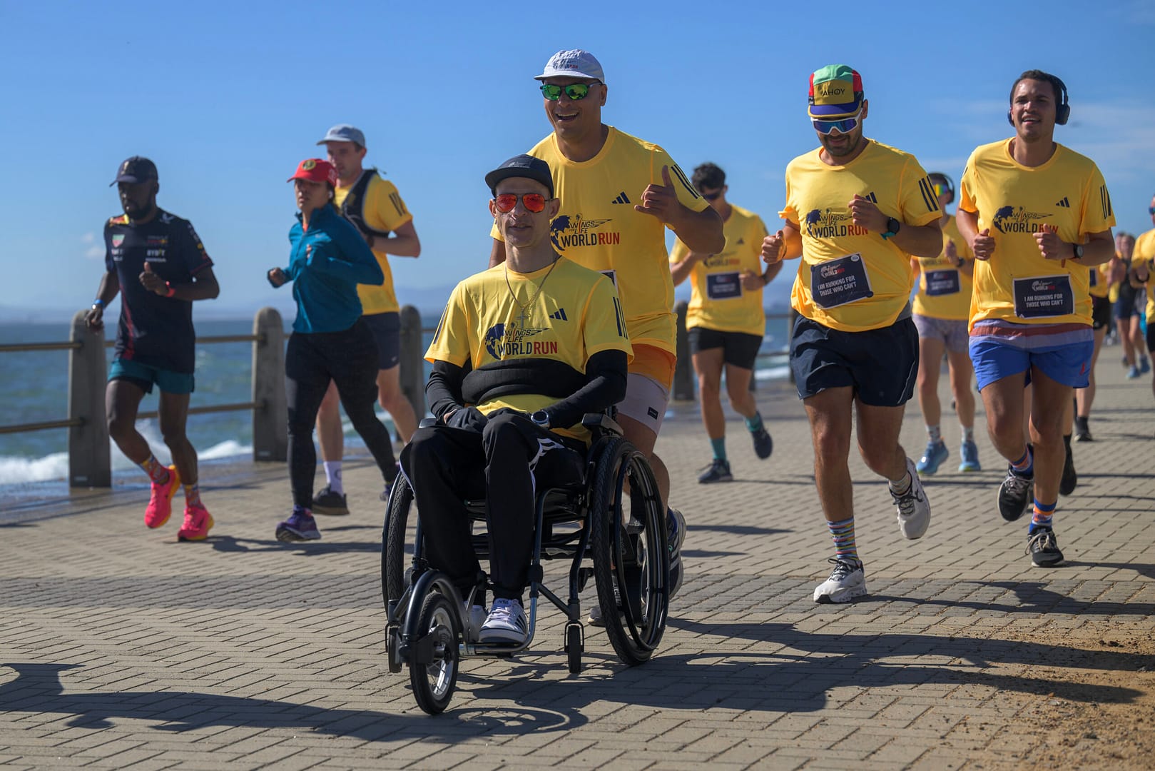 Wings For Life runners and wheelchair participants on Sea Point Promenade