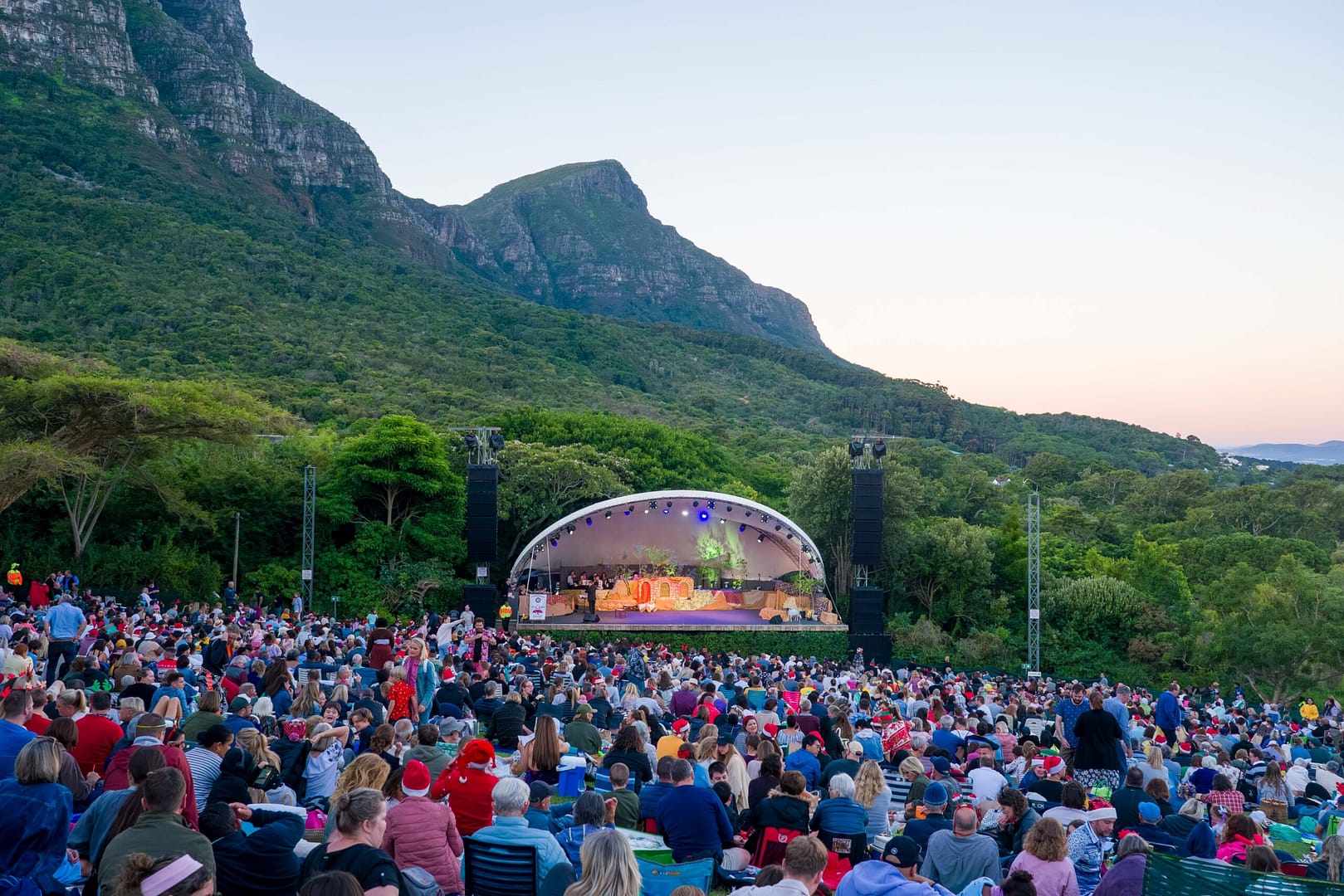 Crowd sitting in front of stage for Christmas carols at Kirstenbosch Botanical Gardens